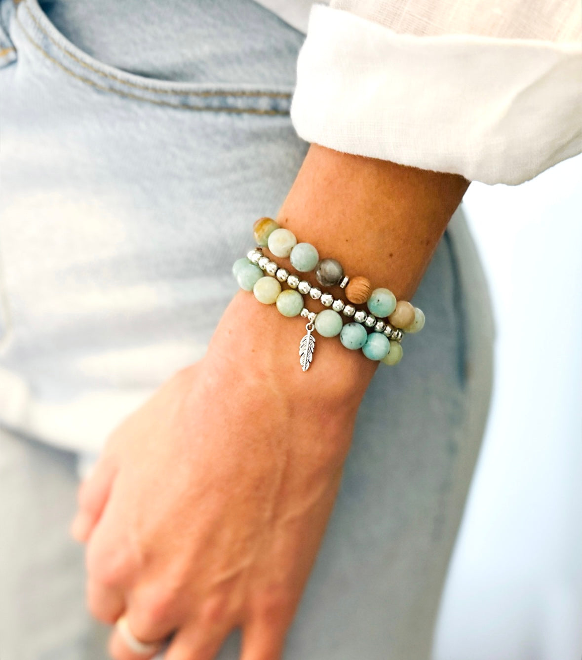 This healing gemstone bracelet stack is crafted with natural Amazonite beads and feather charm. Amazonite is known for its soothing energy, promoting calm and tranquility, and is believed to help balance the emotions, reduce stress and anxiety, and enhance communication. Amazonite brings clarity, balance and insight and is soothing to the nerves.