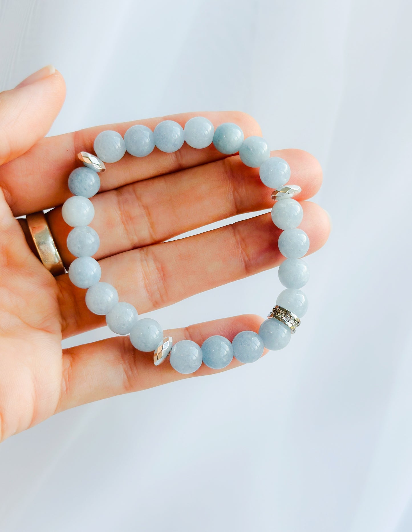 The Aqua Elegance Bracelet is more than just a beautiful accessory; it's a stunning embodiment of the serene and healing energies of aquamarine gemstones. Known for its captivating blue hues reminiscent of tranquil ocean waters, Aquamarine is celebrated for its various metaphysical properties.