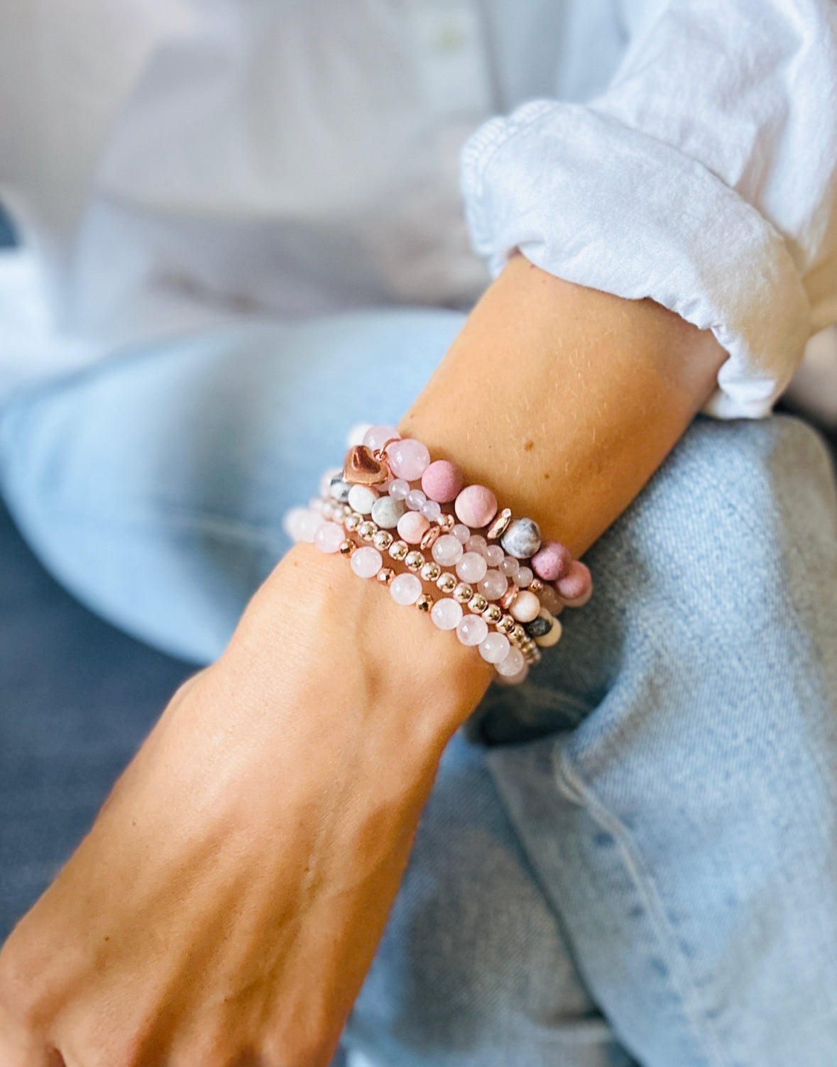 pink gemstone stacking bracelet set with rose quartz, rhodonite, pink zebra jasper and a rose gold heart charm