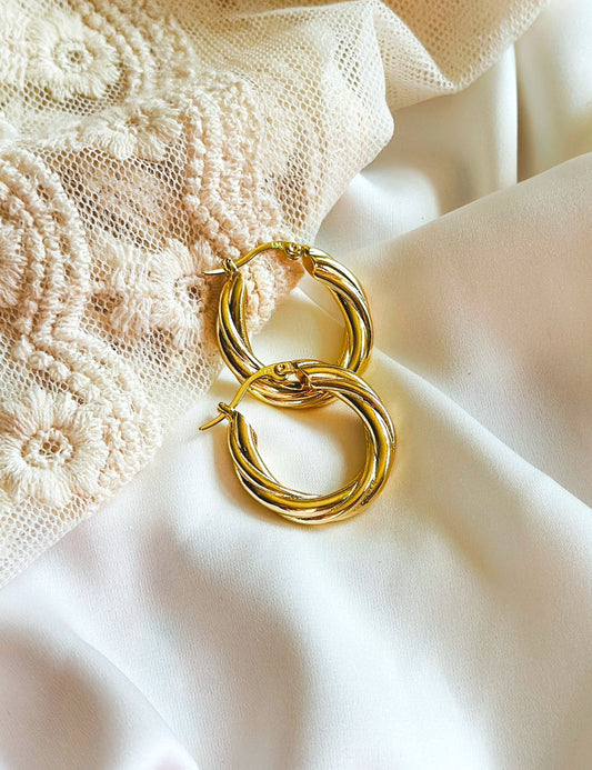 Olivia Earrings: Sterling Silver 18K Gold Plated Twisted Hoops
Elevate your jewelry collection with the exquisite Olivia Earrings. These sterling silver hoops, expertly plated with 18K gold, showcase a timeless twist design that exudes elegance and sophistication.