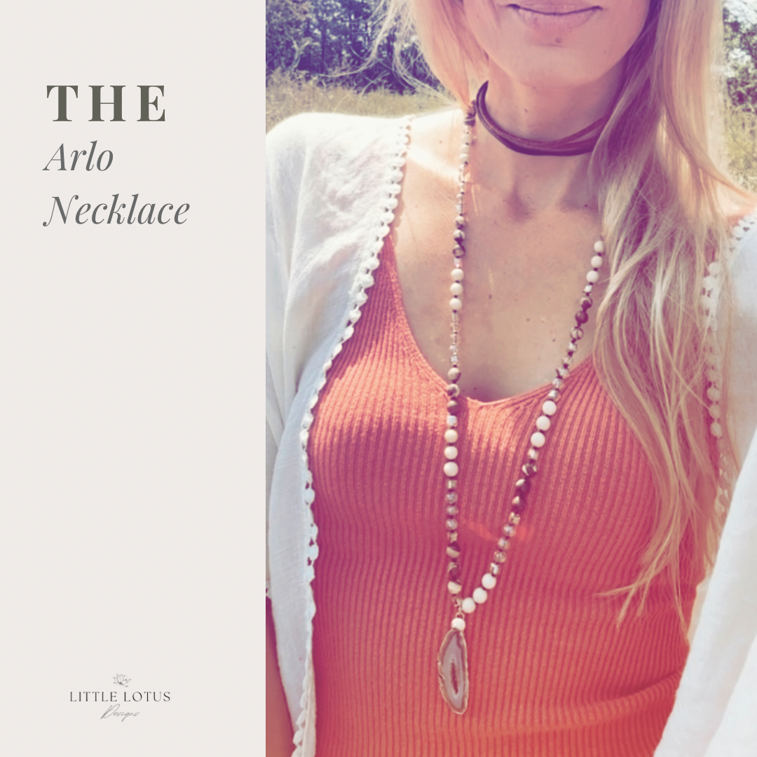 "The Arlo" gemstone necklace, a masterpiece that merges the grounding essence of River Stone Jasper gemstones, the delicate charm of glass beads, and the captivating allure of a Druzy Agate pendant.