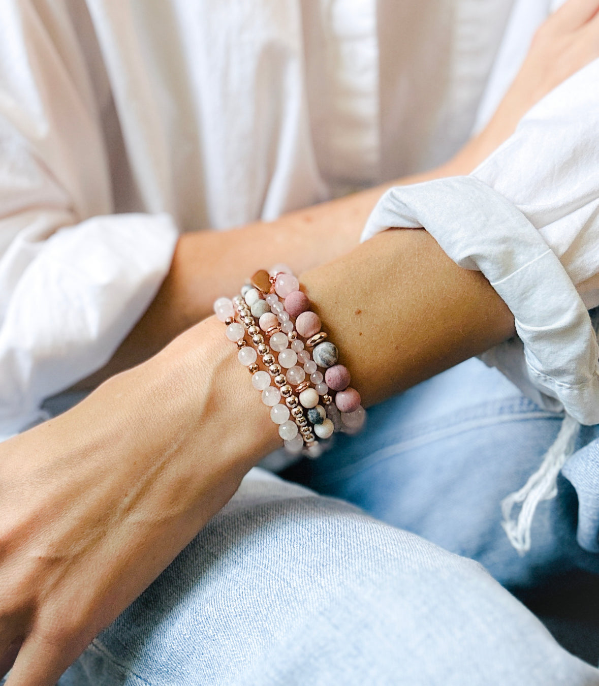 pink gemstone stacking bracelet set with rose quartz, rhodonite, pink zebra jasper and a rose gold heart charm