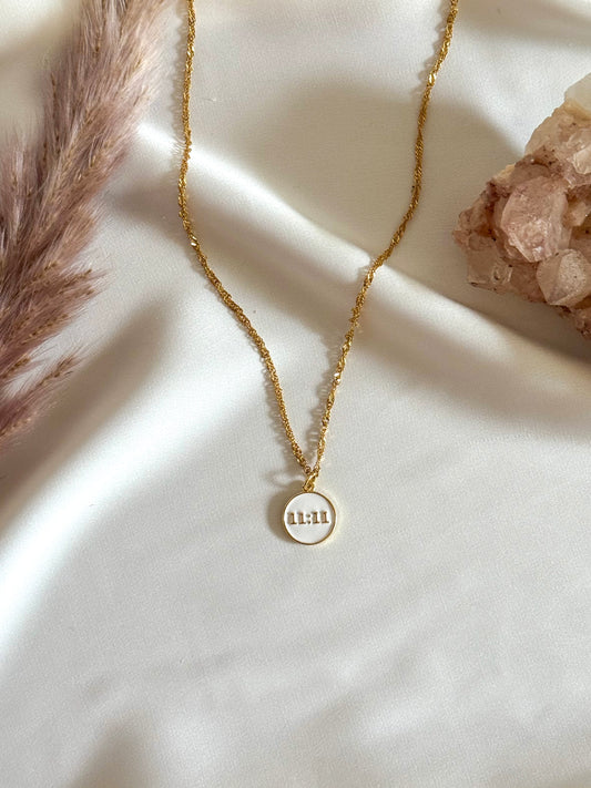 The 11:11 Necklace — a delicate, handcrafted necklace featuring a minimalist pendant representing 11:11. Styled to evoke themes of alignment, synchronicity, and manifestation, perfect as a daily reminder of guidance and intention.