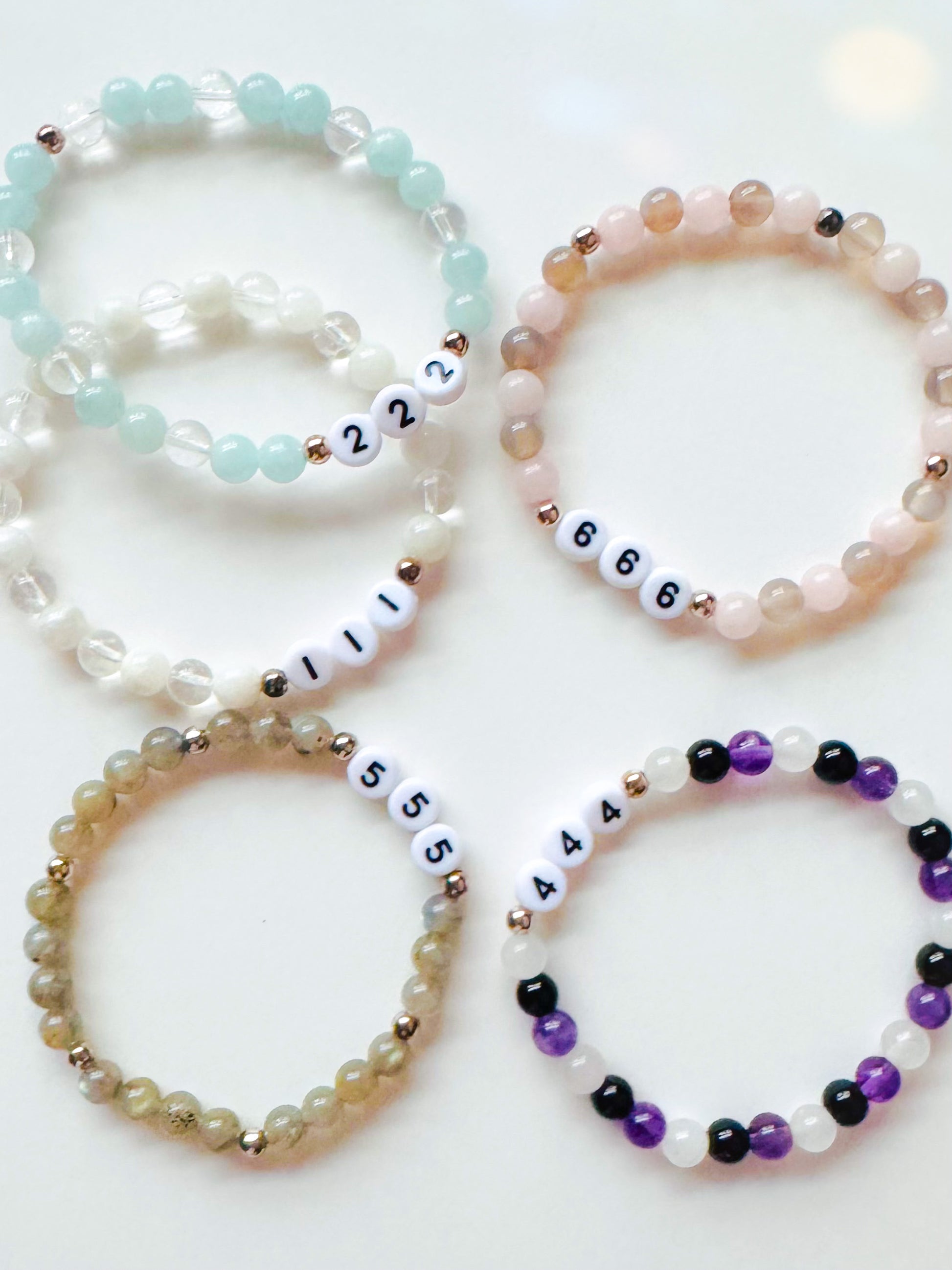 A collection of Angel Number Healing Bracelets, designed to symbolize spiritual guidance and reassurance. Each bracelet represents a unique angel number, offering messages of alignment, protection, and divine support.