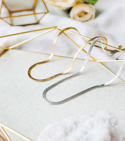 Introducing the Chloe Necklace, a stunning herringbone design meticulously crafted in your choice of sterling silver or elegant 18k gold.