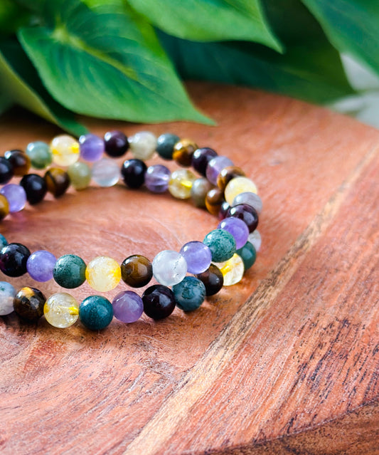 Introducing our exquisite gemstone bracelet, a harmonious blend of Moss Agate, Amethyst, Citrine, Tigers Eye, and Garnet. Crafted with precision and care, each stone contributes unique healing properties to create a holistic synergy.