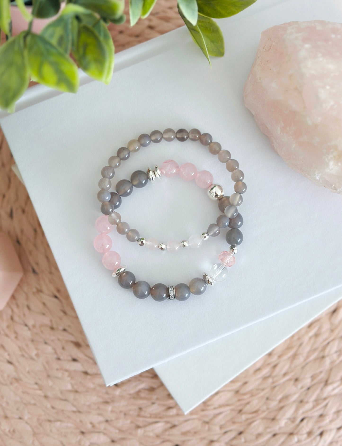 Introducing the "Velvet Rose" gemstone bracelet set, a sublime fusion of gray agate and rose quartz with captivating healing properties. The graceful gray agate, embodying stability and balance, harmonizes seamlessly with the tender energy of rose quartz, the "Stone of Unconditional Love."