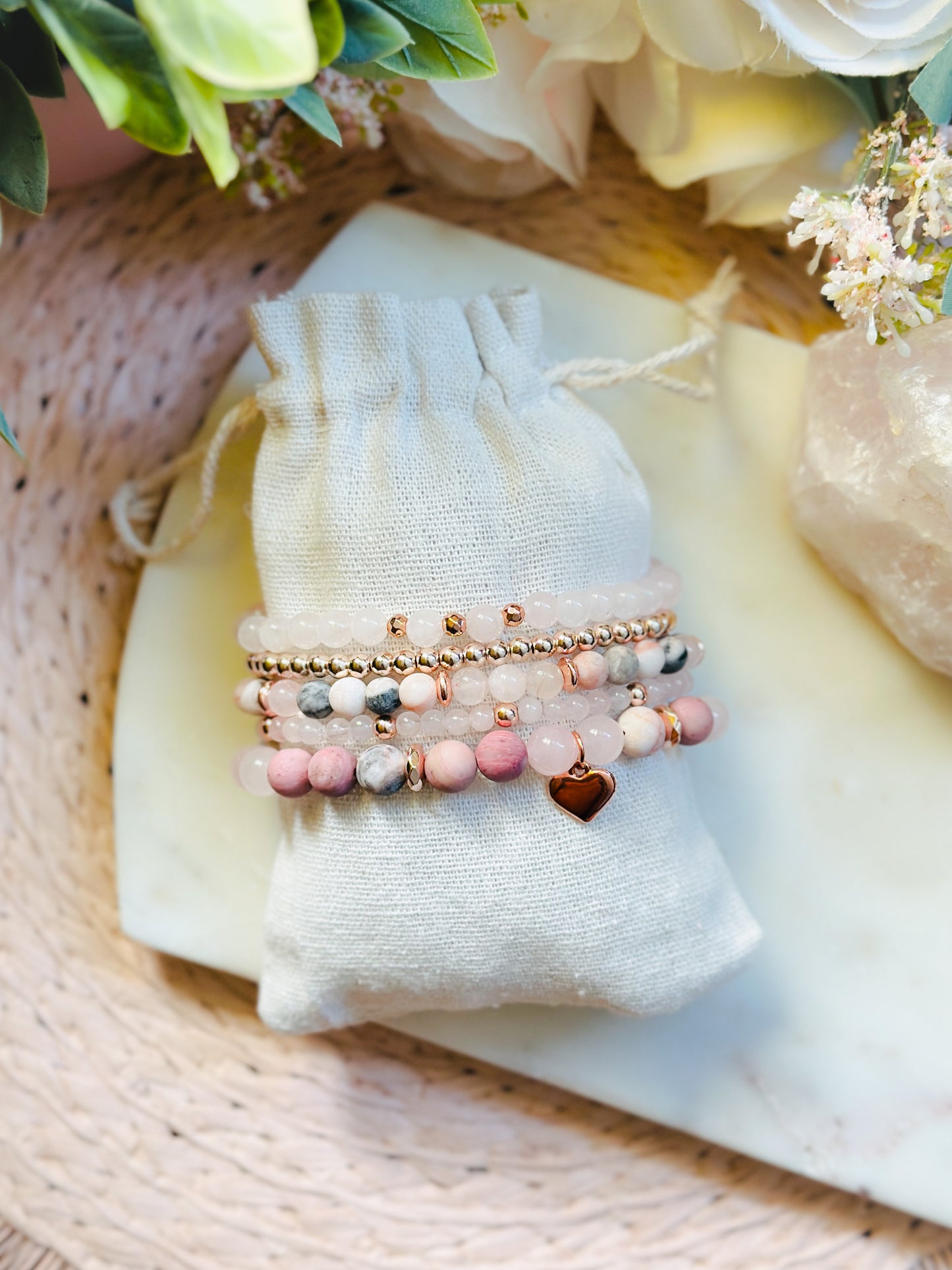 pink gemstone stacking bracelet set with rose quartz, rhodonite, pink zebra jasper and a rose gold heart charm