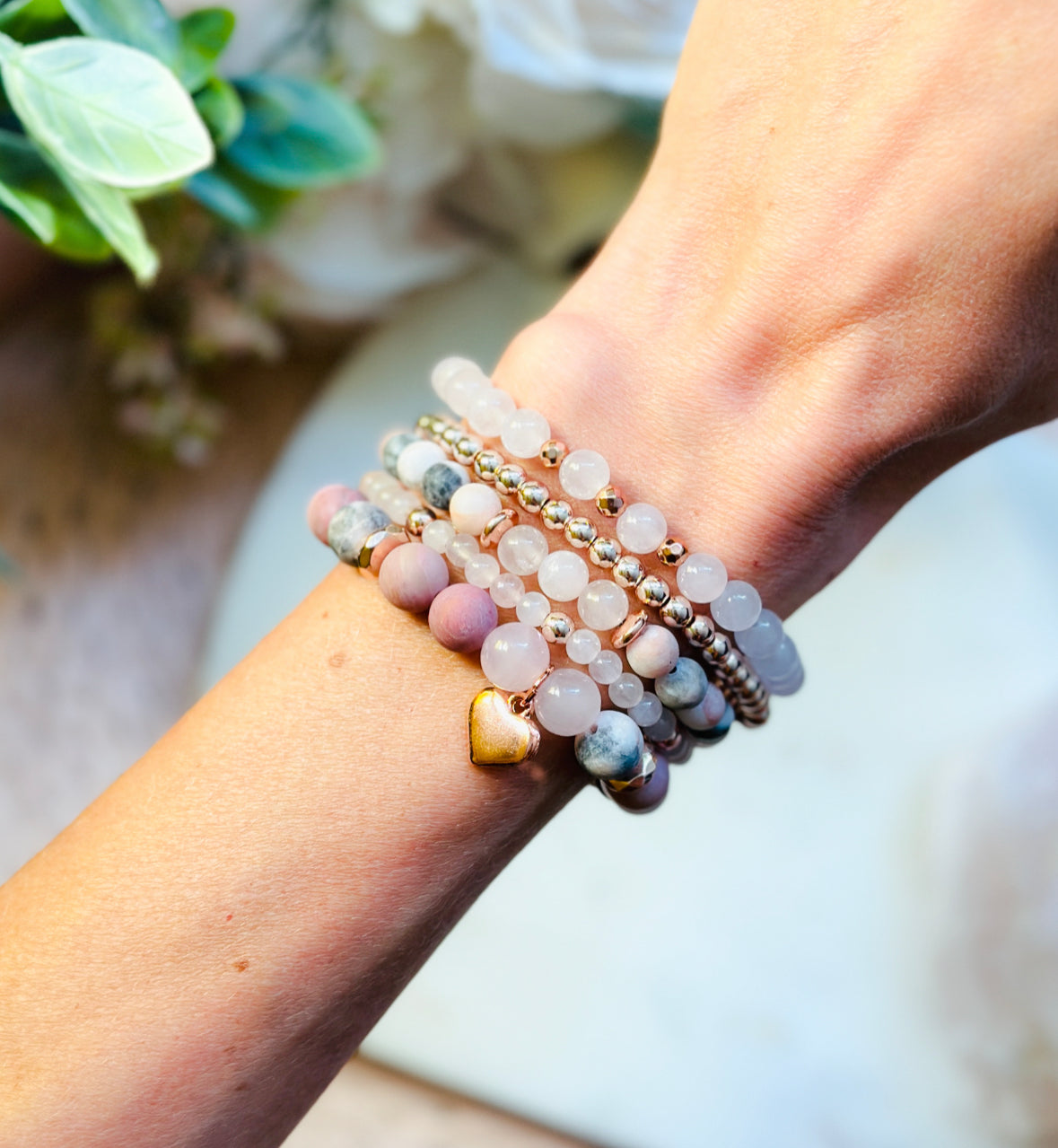 pink gemstone stacking bracelet set with rose quartz, rhodonite, pink zebra jasper and a rose gold heart charm