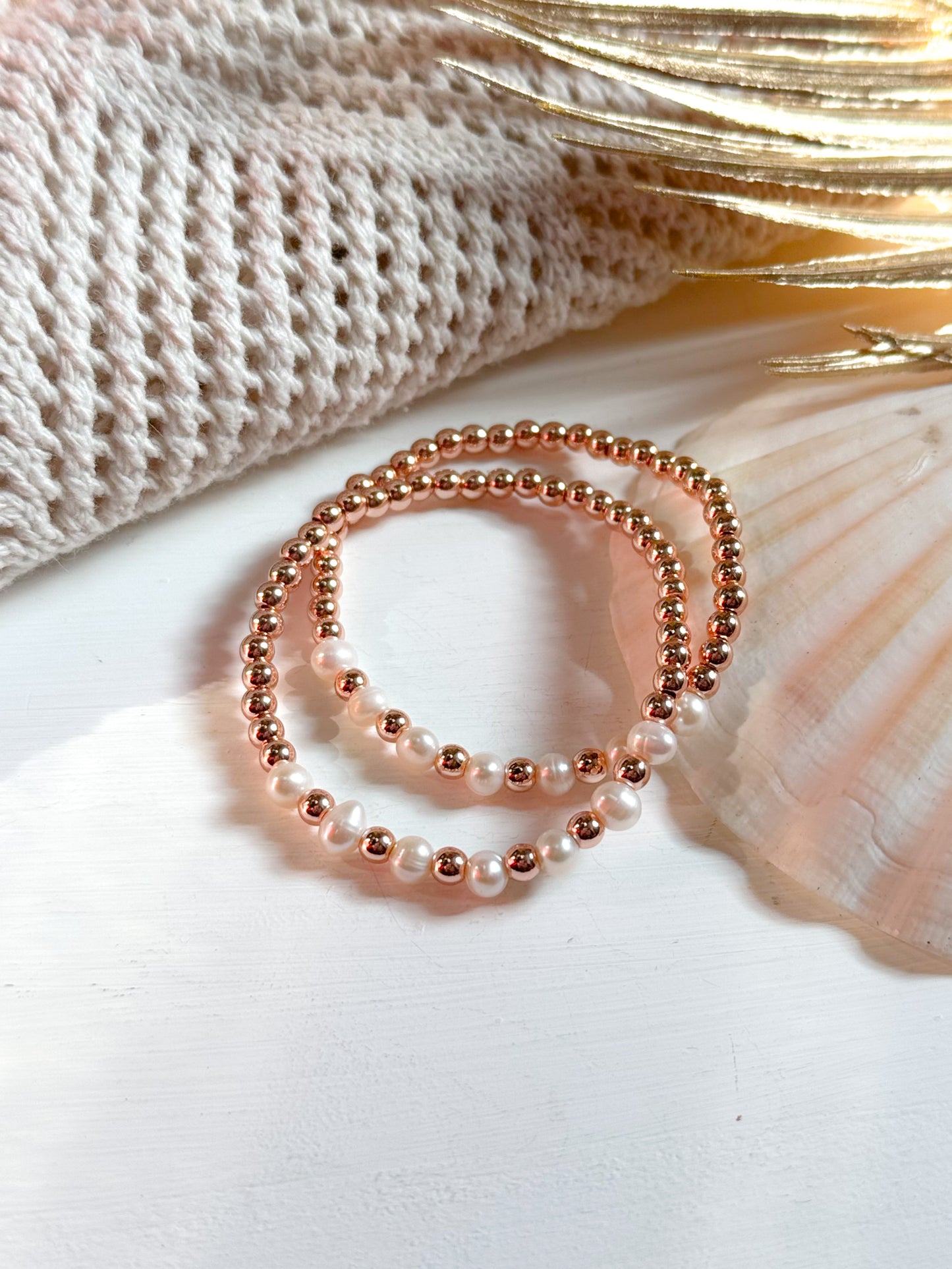 The Amara Bay bracelet features a harmonious blend of rose gold Hematite beads and smooth, luminous Pearls. The design is soft and elegant, evoking coastal serenity. The warm metallic shimmer of the Hematite contrasts gently with the creamy white Pearls, creating a refined and calming aesthetic.