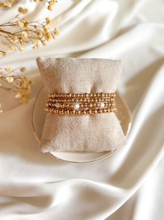 The Sophia Loren Set — a handcrafted bracelet stack featuring gold hematite beads and luminous pearls. Styled to be elegant, timeless, and glamorous, perfect for adding a touch of sparkle and sophistication to everyday outfits.