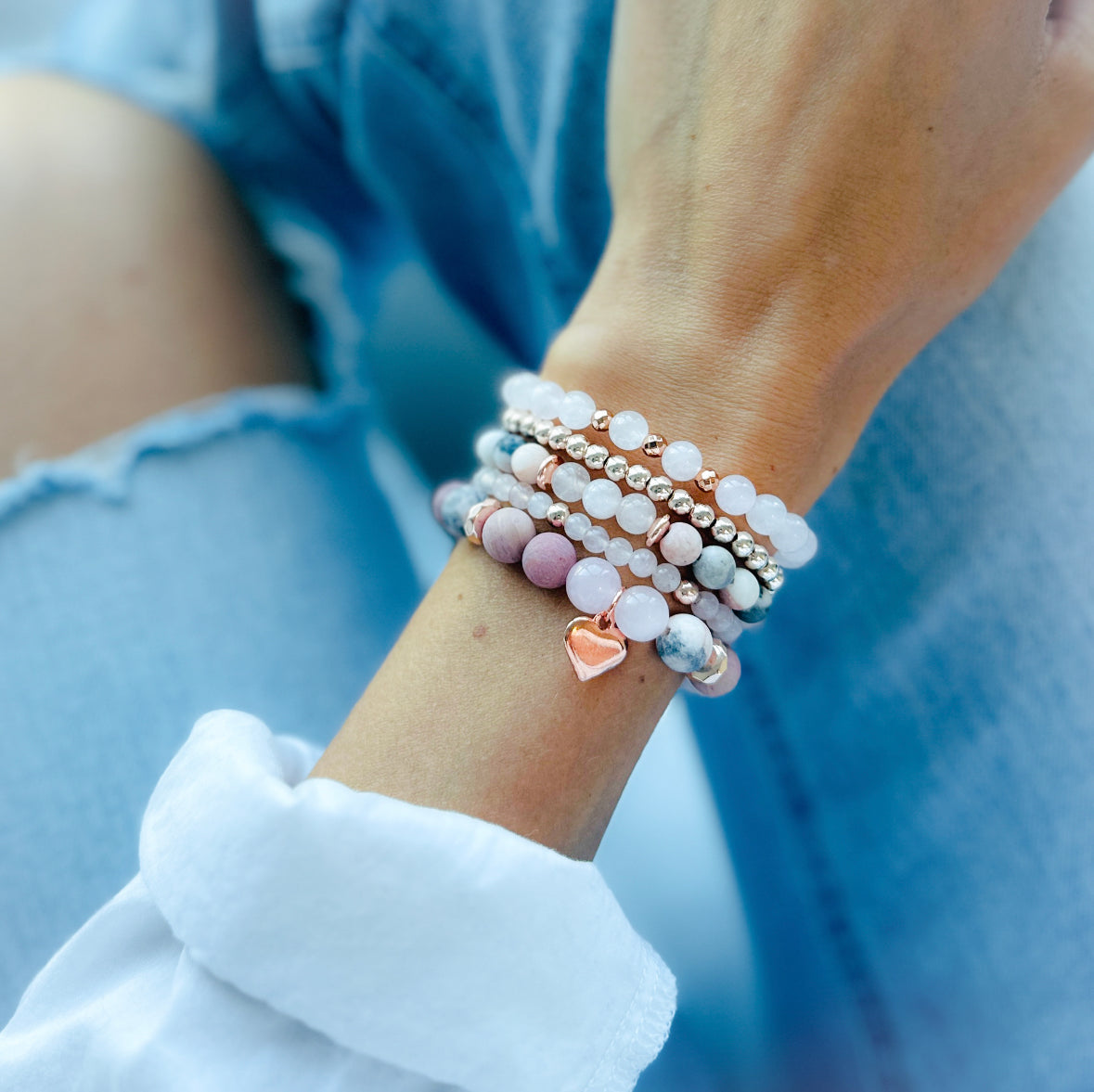 pink gemstone stacking bracelet set with rose quartz, rhodonite, pink zebra jasper and a rose gold heart charm