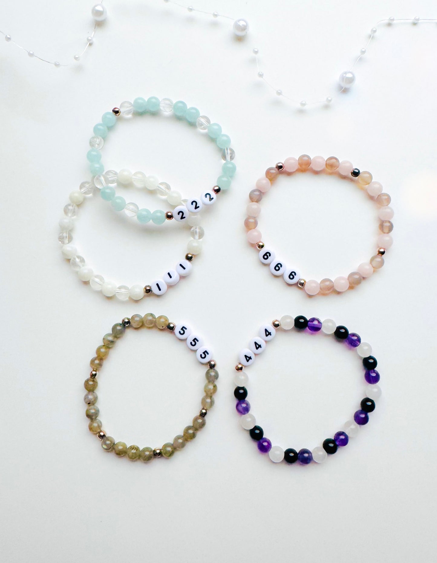 A collection of Angel Number Healing Bracelets, designed to symbolize spiritual guidance and reassurance. Each bracelet represents a unique angel number, offering messages of alignment, protection, and divine support.
