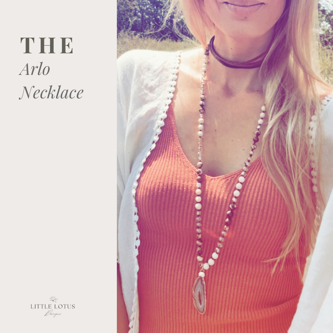 "The Arlo" gemstone necklace, a masterpiece that merges the grounding essence of River Stone Jasper gemstones, the delicate charm of glass beads, and the captivating allure of a Druzy Agate pendant. 