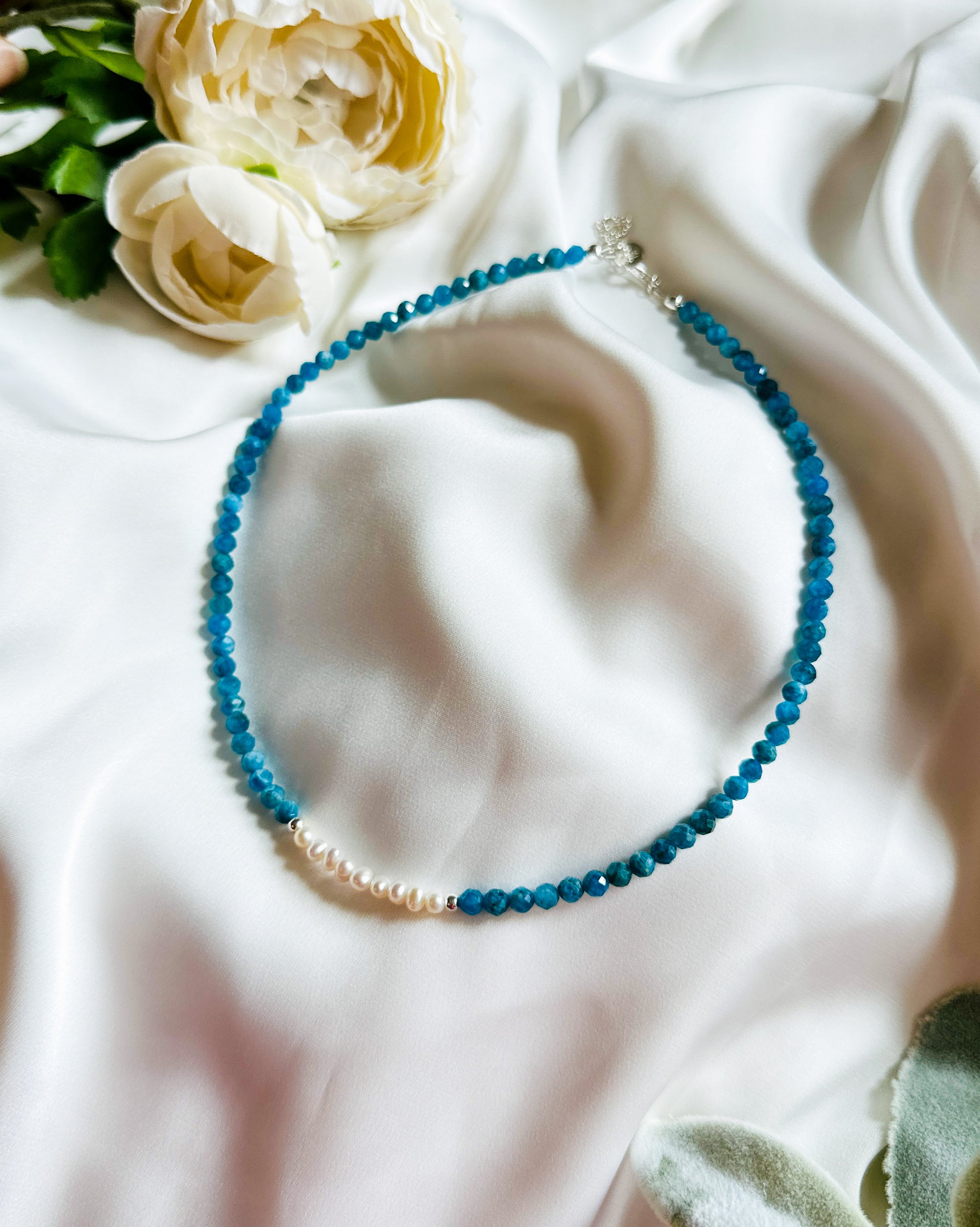 The Anastasia Gemstone Necklace – an exquisite blend of Apatite, freshwater pearls, and silver findings, meticulously crafted to inspire elegance and promote inner harmony.

