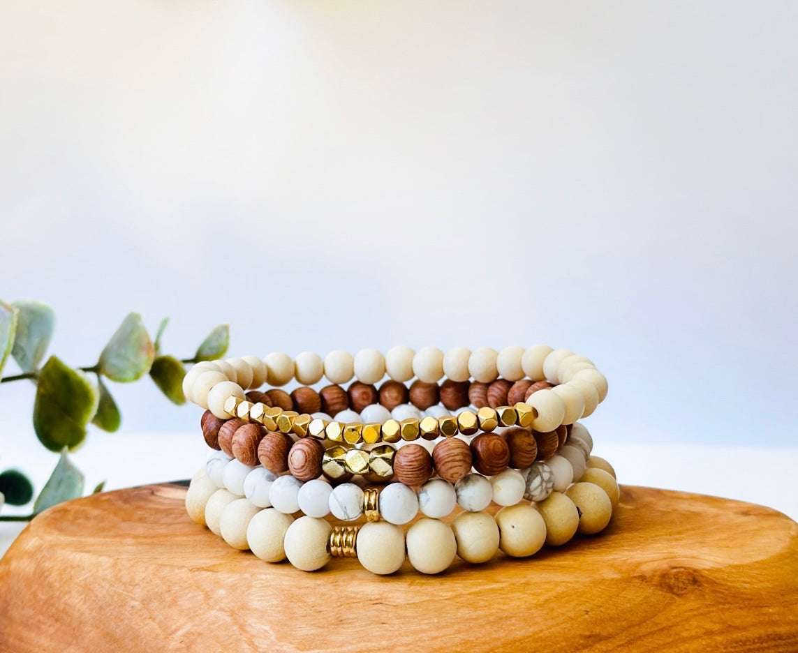 gemstone bracelet stacking set with whitewood, howlite, rosewood and lava rock called the golden goddess stacking set