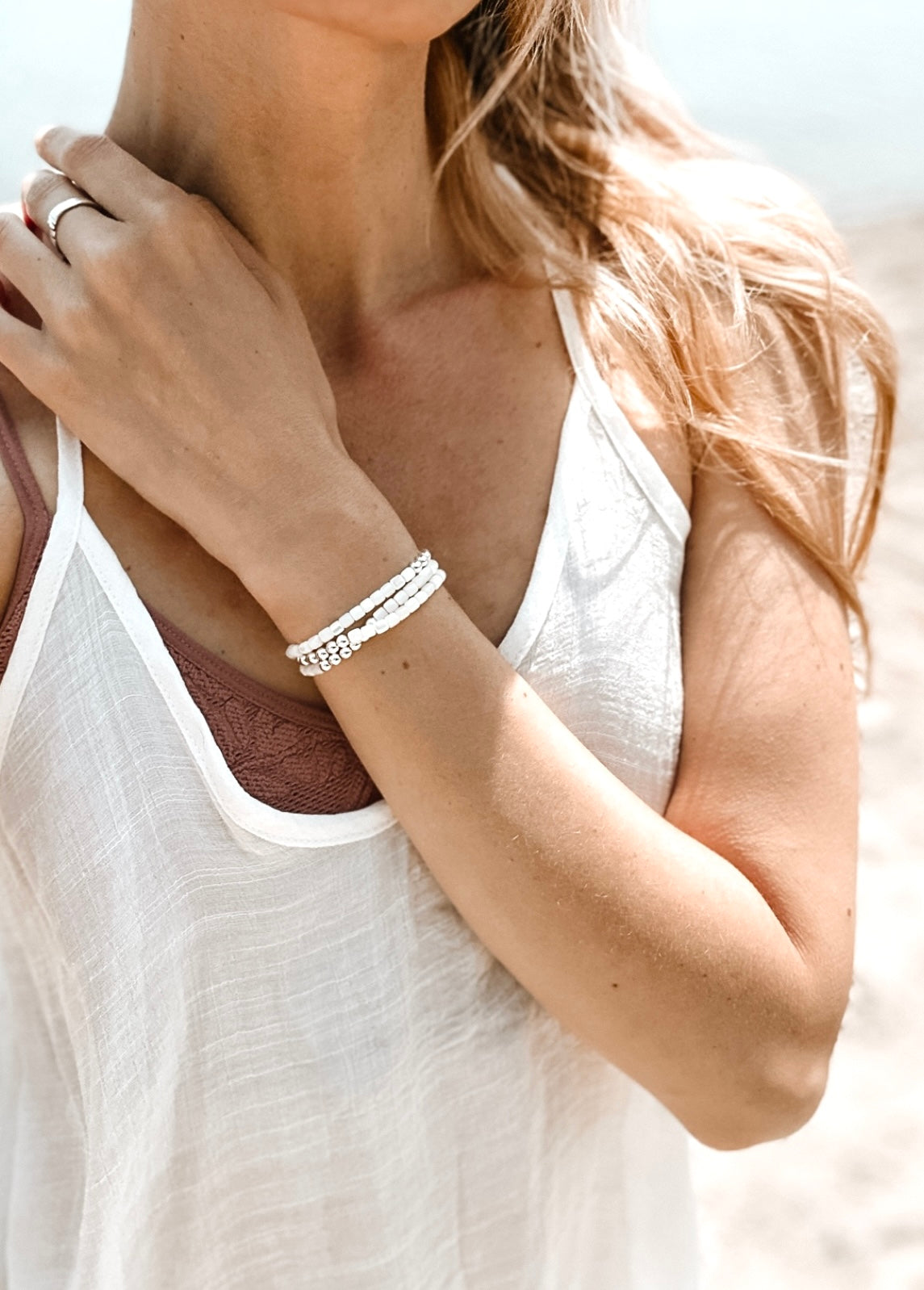 Introducing The Malia Double Wrap Bracelet, a captivating blend of elegance and healing energy. This exquisite bracelet features lustrous Mother of Pearl shell beads, known for their calming and nurturing properties. Each bead reflects a spectrum of iridescent hues, evoking the tranquil beauty of the ocean.