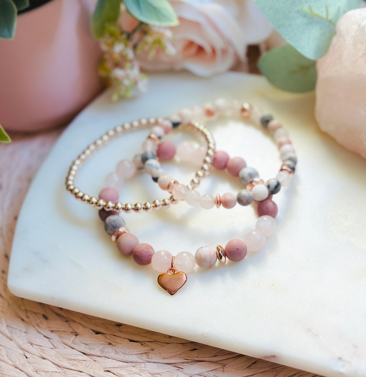 pink gemstone stacking bracelet set with rose quartz, rhodonite, pink zebra jasper and a rose gold heart charm