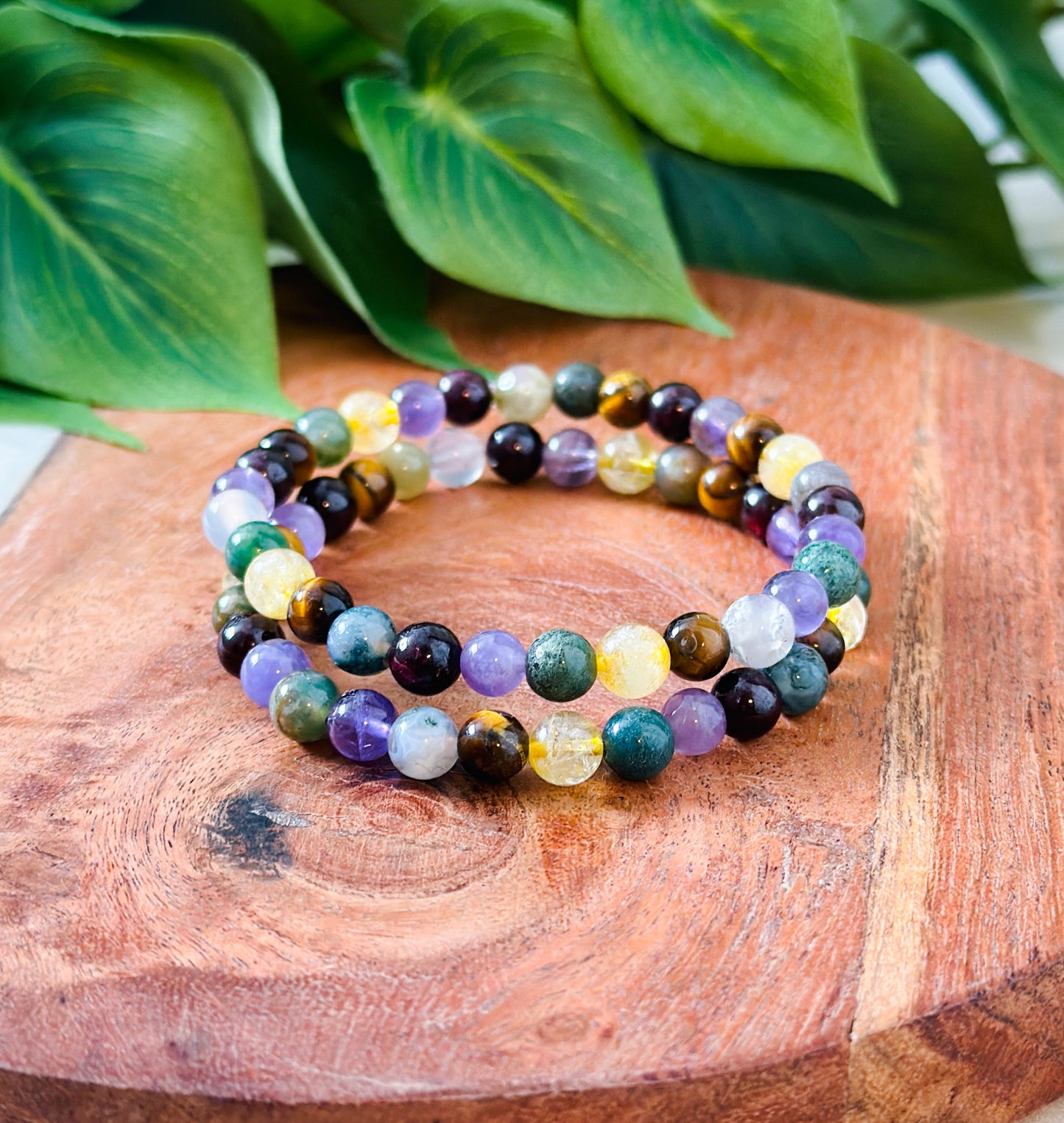Introducing our exquisite gemstone bracelet, a harmonious blend of Moss Agate, Amethyst, Citrine, Tigers Eye, and Garnet. Crafted with precision and care, each stone contributes unique healing properties to create a holistic synergy.
