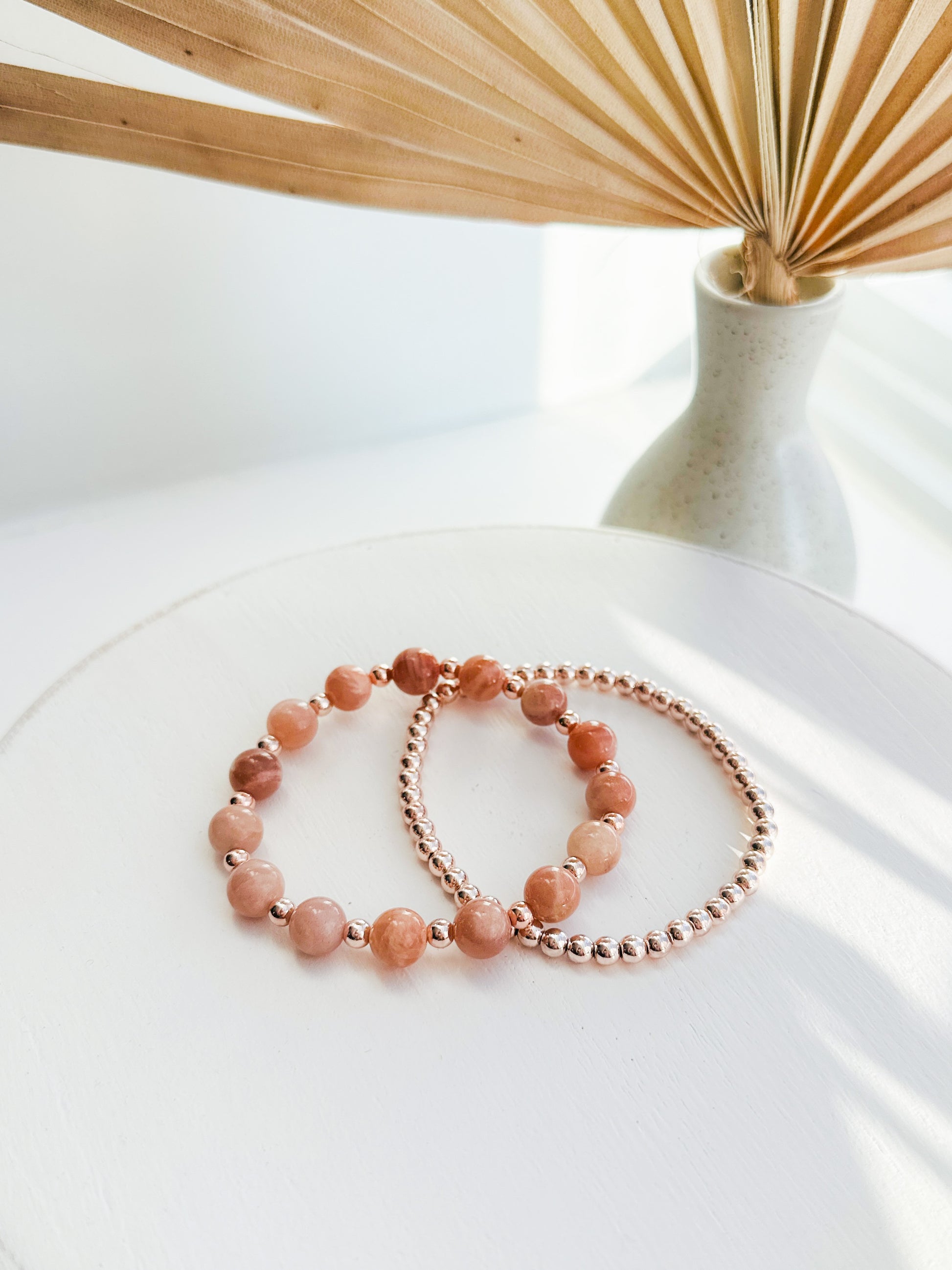 Introducing our exquisite gemstone bracelet set, crafted with the powerful energies of Sunstone and the elegance of Rose Gold Hematite.

Sunstone, known for its radiant warmth, promotes joy, vitality, and personal power. Complementing this, Rose Gold Hematite is believed to bring balance, grounding, and a sense of tranquility.

