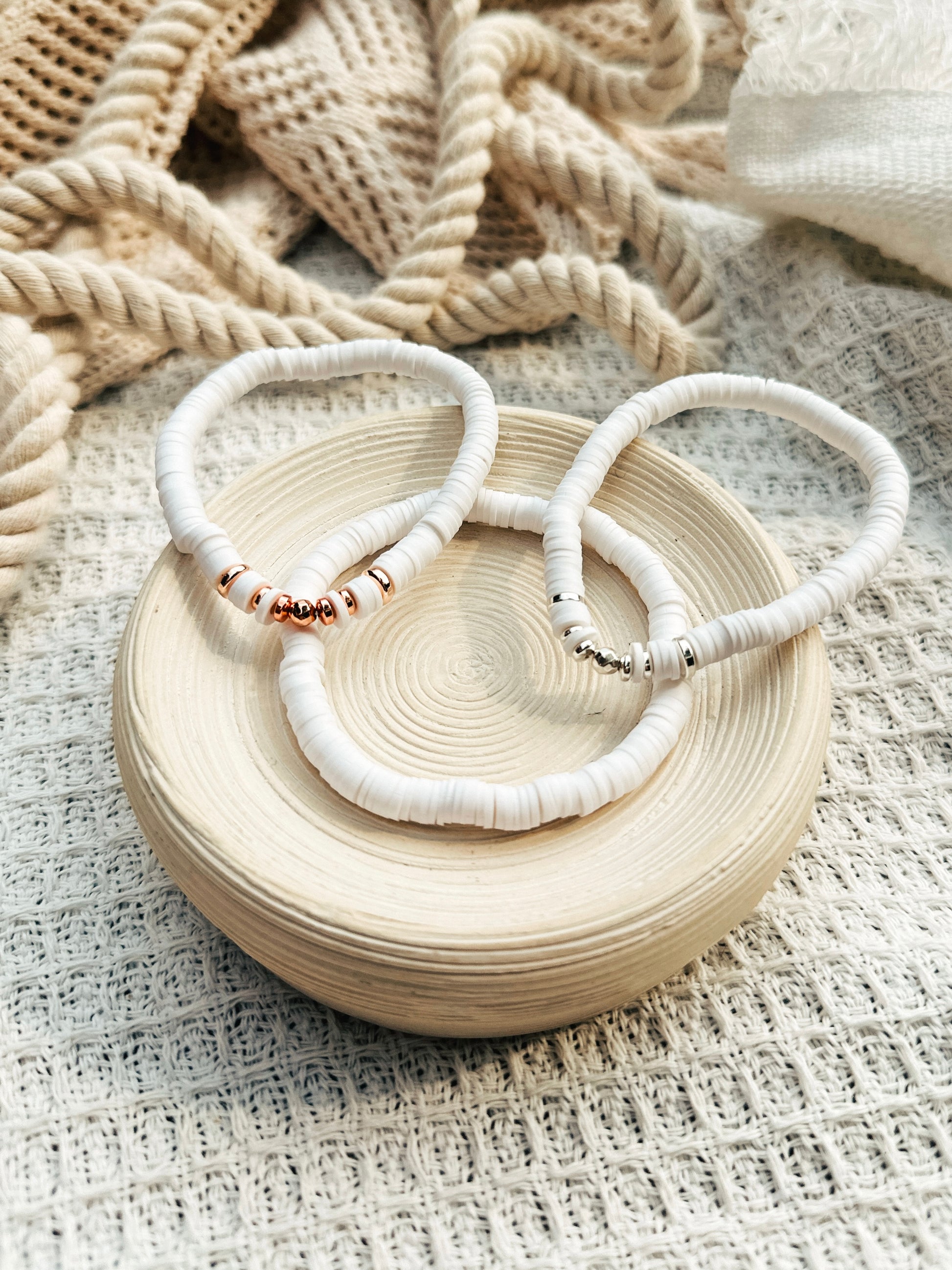 Introducing The Naya Bracelets, a beautiful collection crafted from white polymer clay heishi beads. These bracelets seamlessly blend style and wellness, making them an ideal accessory for any occasion.