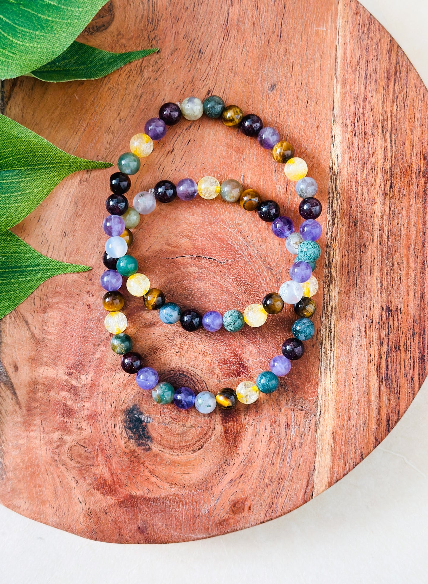 Introducing our exquisite gemstone bracelet, a harmonious blend of Moss Agate, Amethyst, Citrine, Tigers Eye, and Garnet. Crafted with precision and care, each stone contributes unique healing properties to create a holistic synergy.