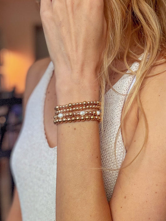 The Sophia Loren Set — a handcrafted bracelet stack featuring gold hematite beads and luminous pearls. Styled to be elegant, timeless, and glamorous, perfect for adding a touch of sparkle and sophistication to everyday outfits.