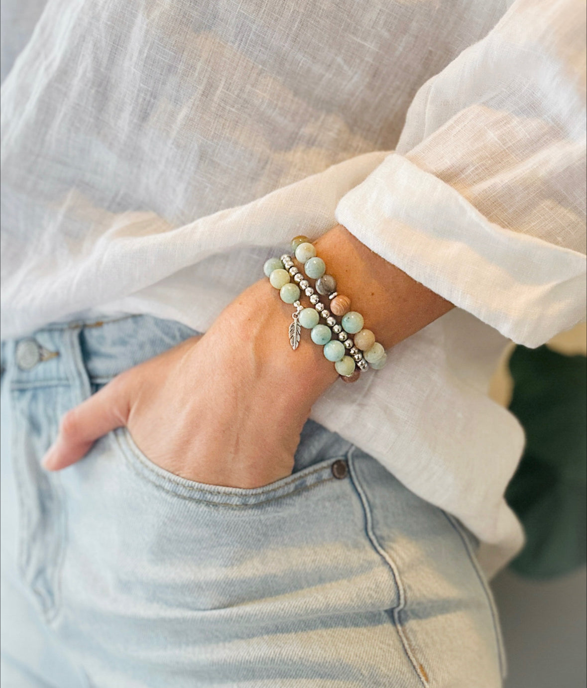 This healing gemstone bracelet stack is crafted with natural Amazonite beads and  feather charm.   Amazonite is known for its soothing energy, promoting calm and tranquility, and is believed to help balance the emotions, reduce stress and anxiety, and enhance communication. Amazonite brings clarity, balance and insight and is soothing to the nerves.