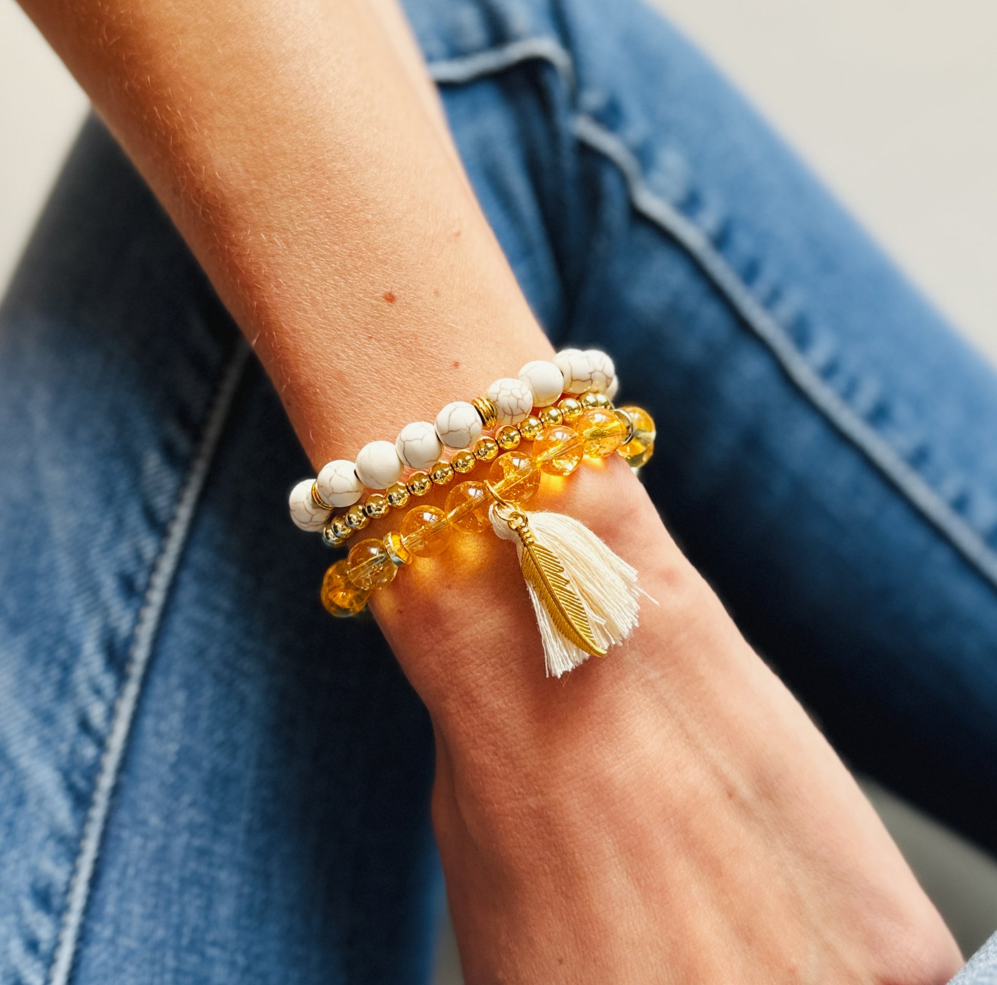 "Citrine" Gemstone Bracelet Set, thoughtfully designed to enhance your well-being and connect you with the powerful energies of Citrine and Magnesite Turquoise. This set features a charming feather charm and a tassel for essential oils,