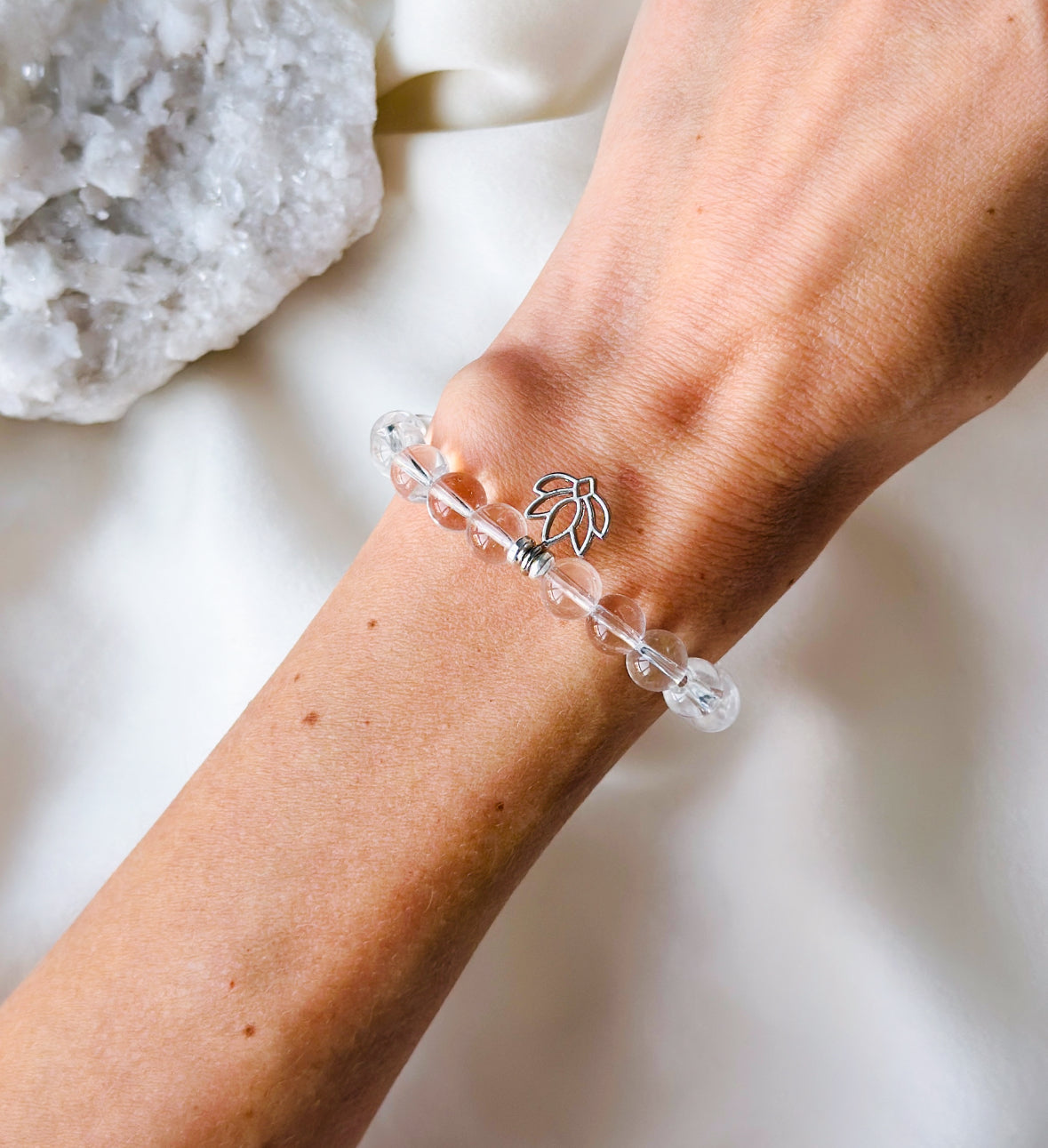  the "Luminescent Lotus Bracelet," a sublime fusion of Clear Quartz and a Lotus charm, 