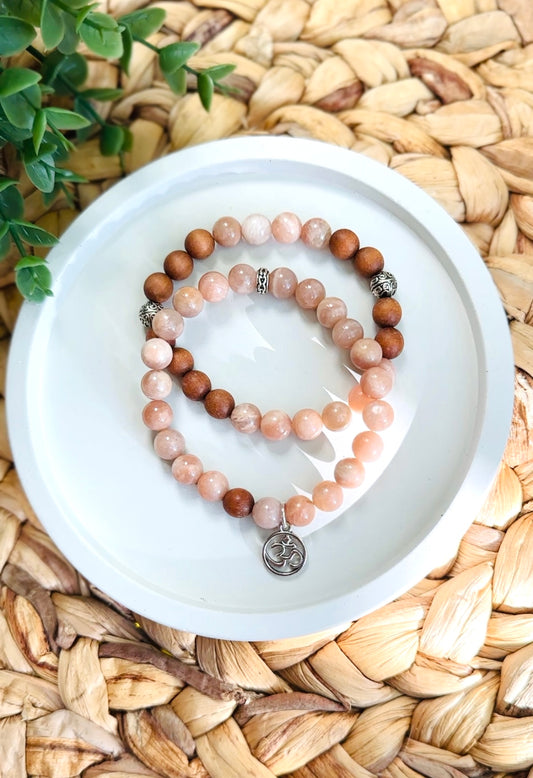 Gemstone bracelets Sunstone to bring joy and vitality.
Sandalwood for grounding and calming energy.
The Om charm represents spiritual harmony.
Together they create a set promoting positivity, relaxation, and spiritual balance.