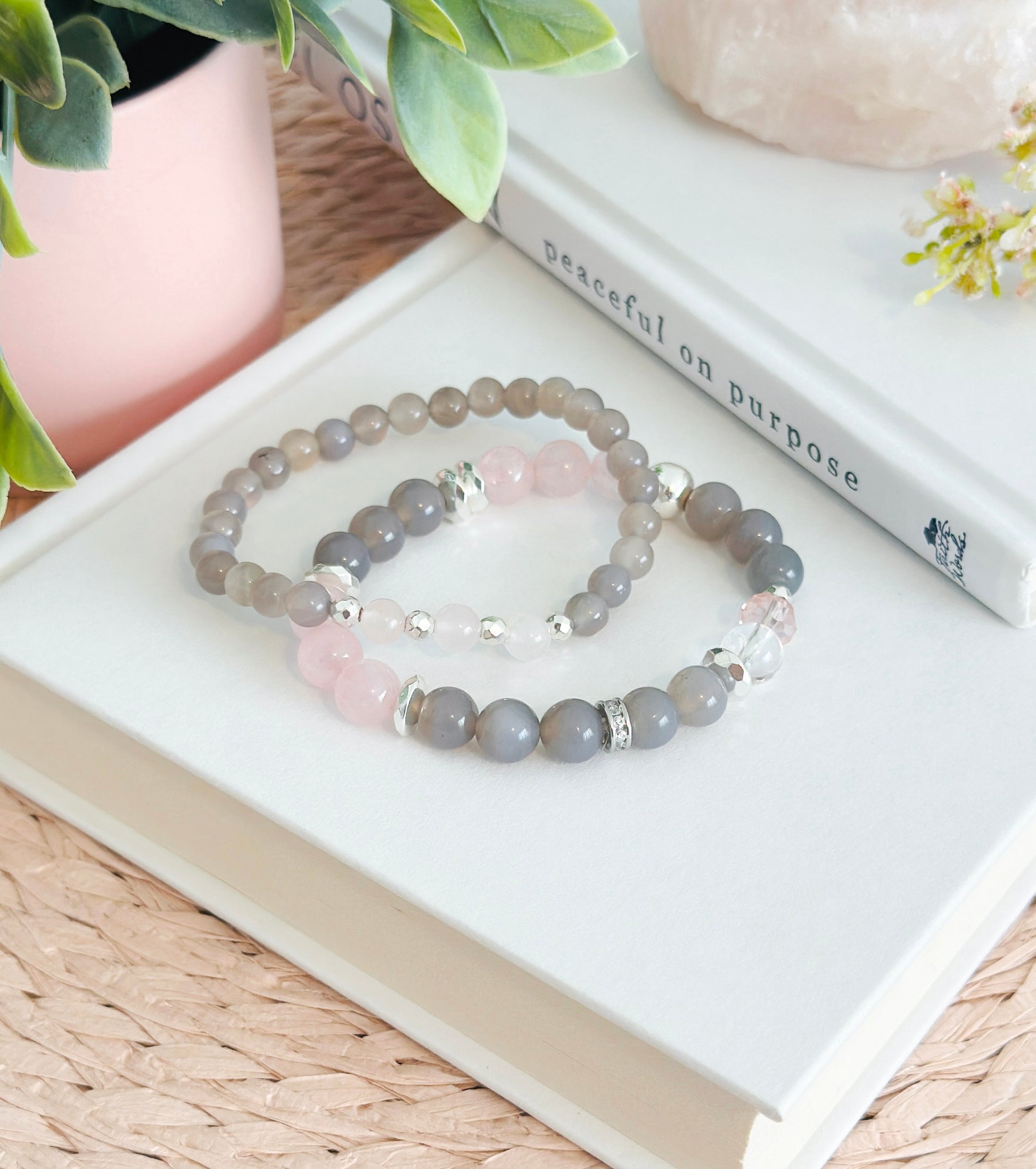 Introducing the "Velvet Rose" gemstone bracelet set, a sublime fusion of gray agate and rose quartz with captivating healing properties. The graceful gray agate, embodying stability and balance, harmonizes seamlessly with the tender energy of rose quartz, the "Stone of Unconditional Love."