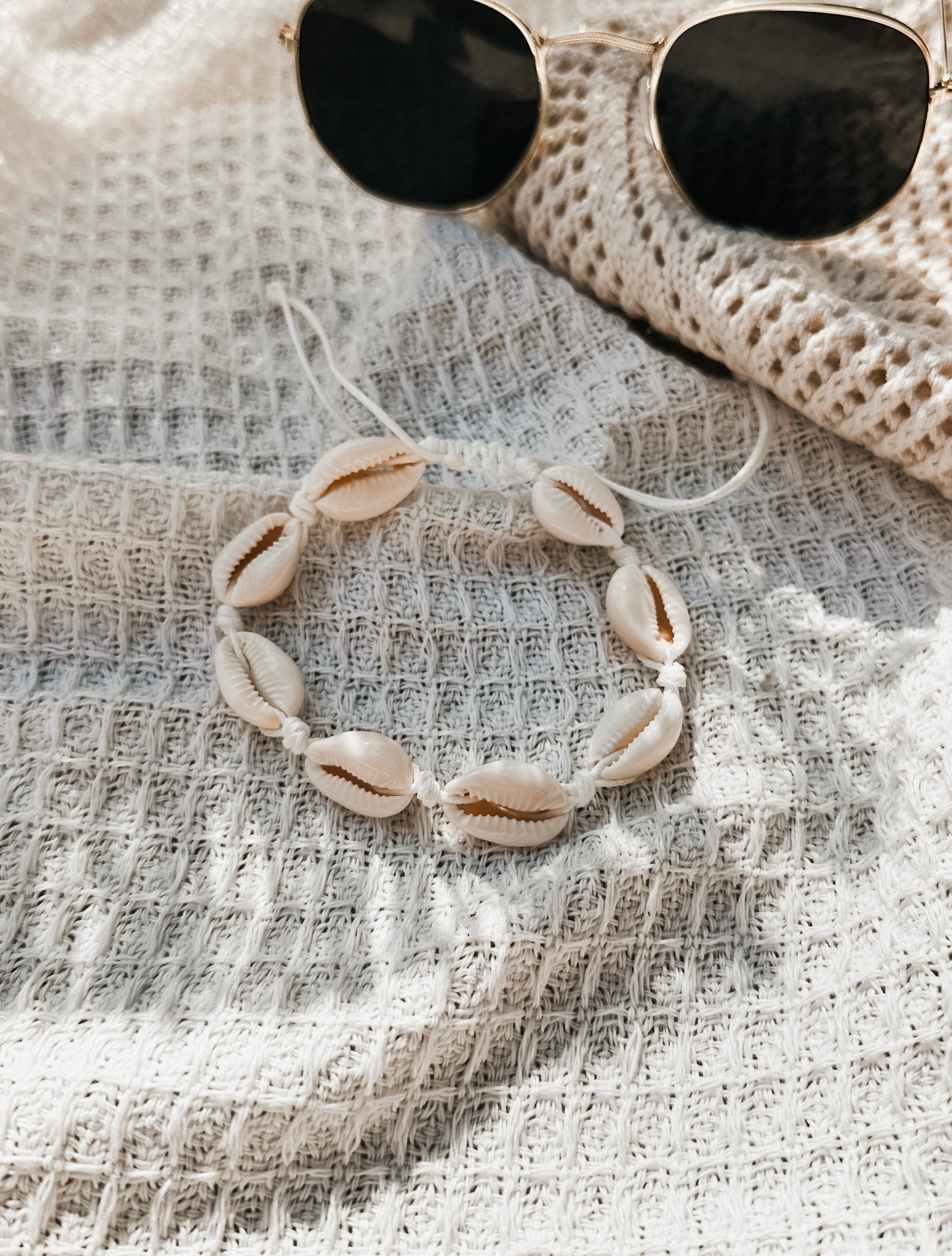 The Ariel Anklet, a versatile accessory perfect for beach lovers and free spirits alike. Crafted with natural hemp twine and adorned with genuine cowrie shells, this anklet captures the essence of coastal charm.

