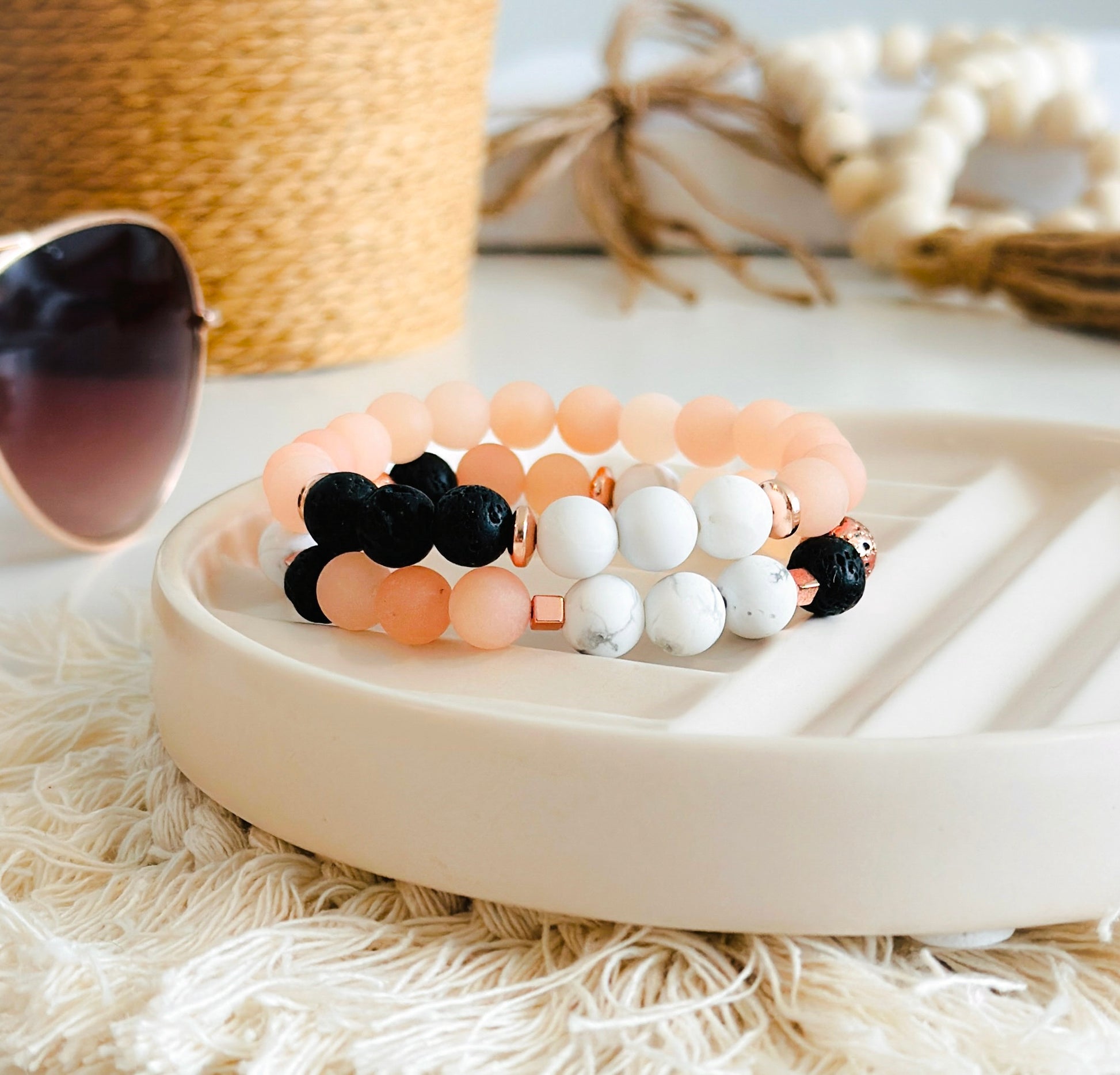 exquisite gemstone bracelet set, meticulously crafted with the powerful healing properties of matte Sunstone, Howlite, and Lava Rock.