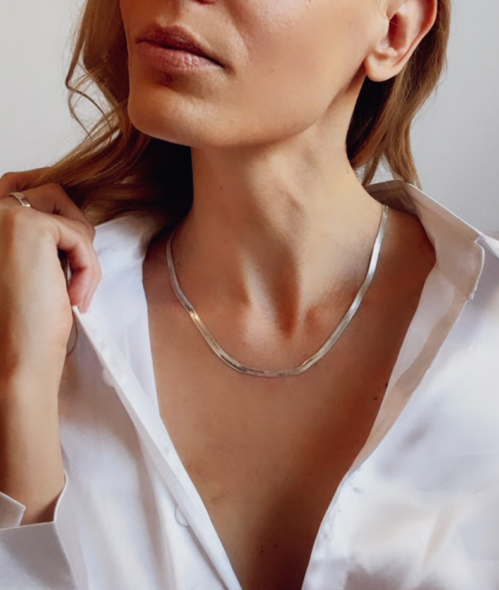Introducing the Chloe Necklace, a stunning herringbone design meticulously crafted in your choice of sterling silver or elegantly plated with 18k gold. 
