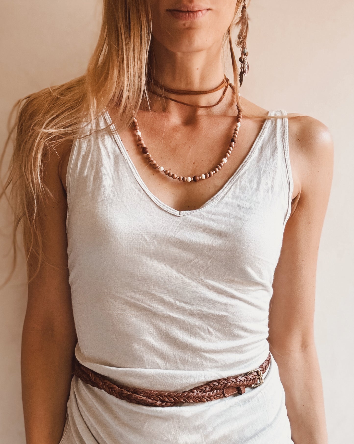 Bohemian-style necklace featuring 6mm rosewood beads, Gmelina wood and 8mm sandalwood beads spaced throughout, accented with light pink rosegold seed beads, strung on stretch cord, laid flat on a neutral background. Natural earthy tones with soft pink highlights, perfect for a boho, feminine look.