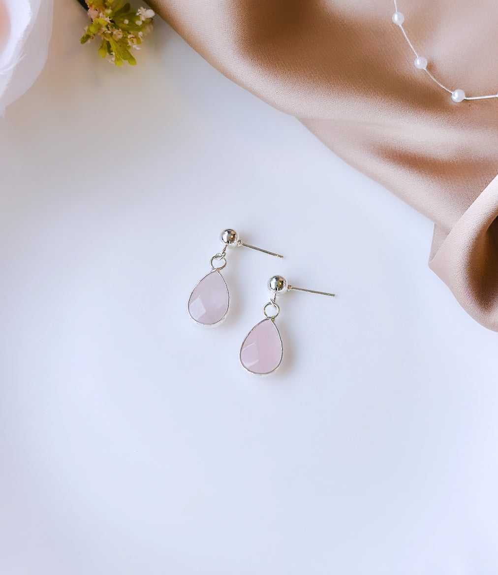 Elevate your style with the Bella Earrings, featuring exquisite Sterling Silver craftsmanship and adorned with Rose Quartz droplet gemstones.