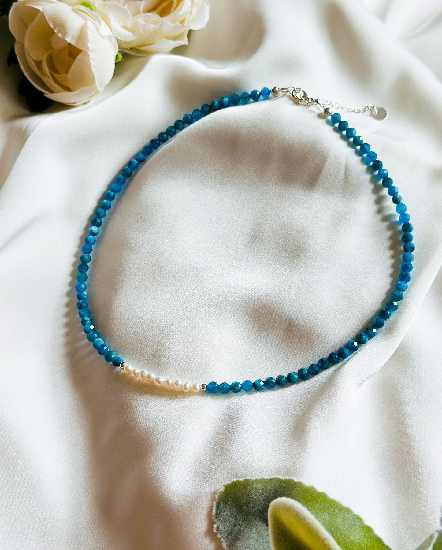 The Anastasia Gemstone Necklace – an exquisite blend of Apatite, freshwater pearls, and silver findings, meticulously crafted to inspire elegance and promote inner harmony.

