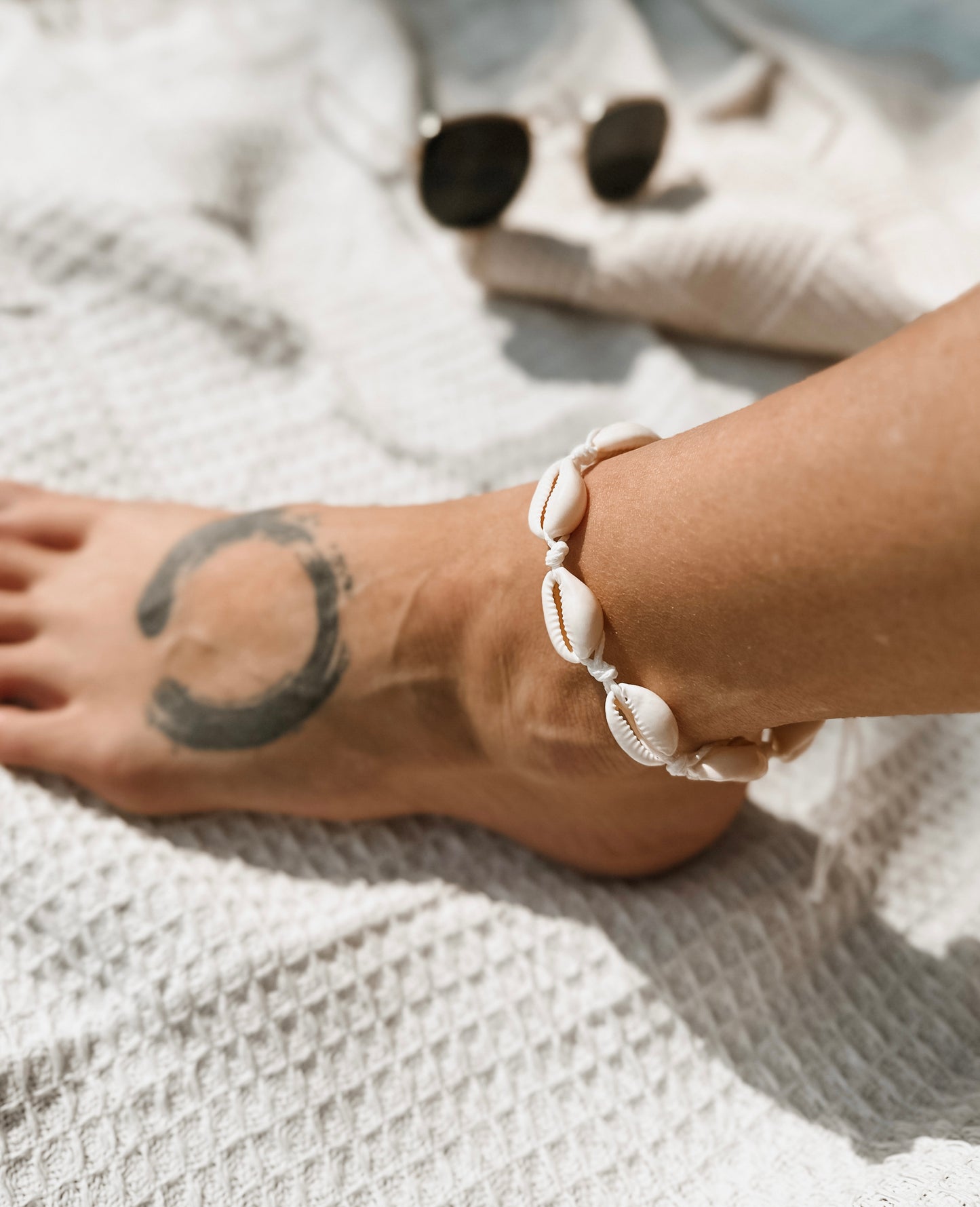 The Ariel Anklet, a versatile accessory perfect for beach lovers and free spirits alike. Crafted with natural hemp twine and adorned with genuine cowrie shells, this anklet captures the essence of coastal charm.

