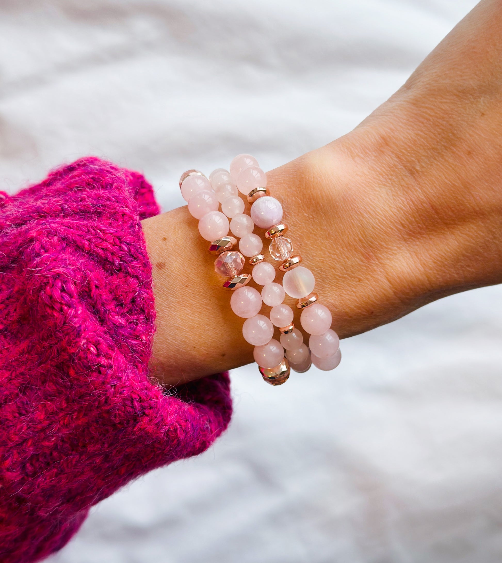 A gemstone bracelet set a captivating ensemble meticulously crafted with the soothing energies of Rose Quartz, the enchanting iridescence of Aura Quartz, the serene vibes of Kunzite, and the soft allure of pink glass beads.