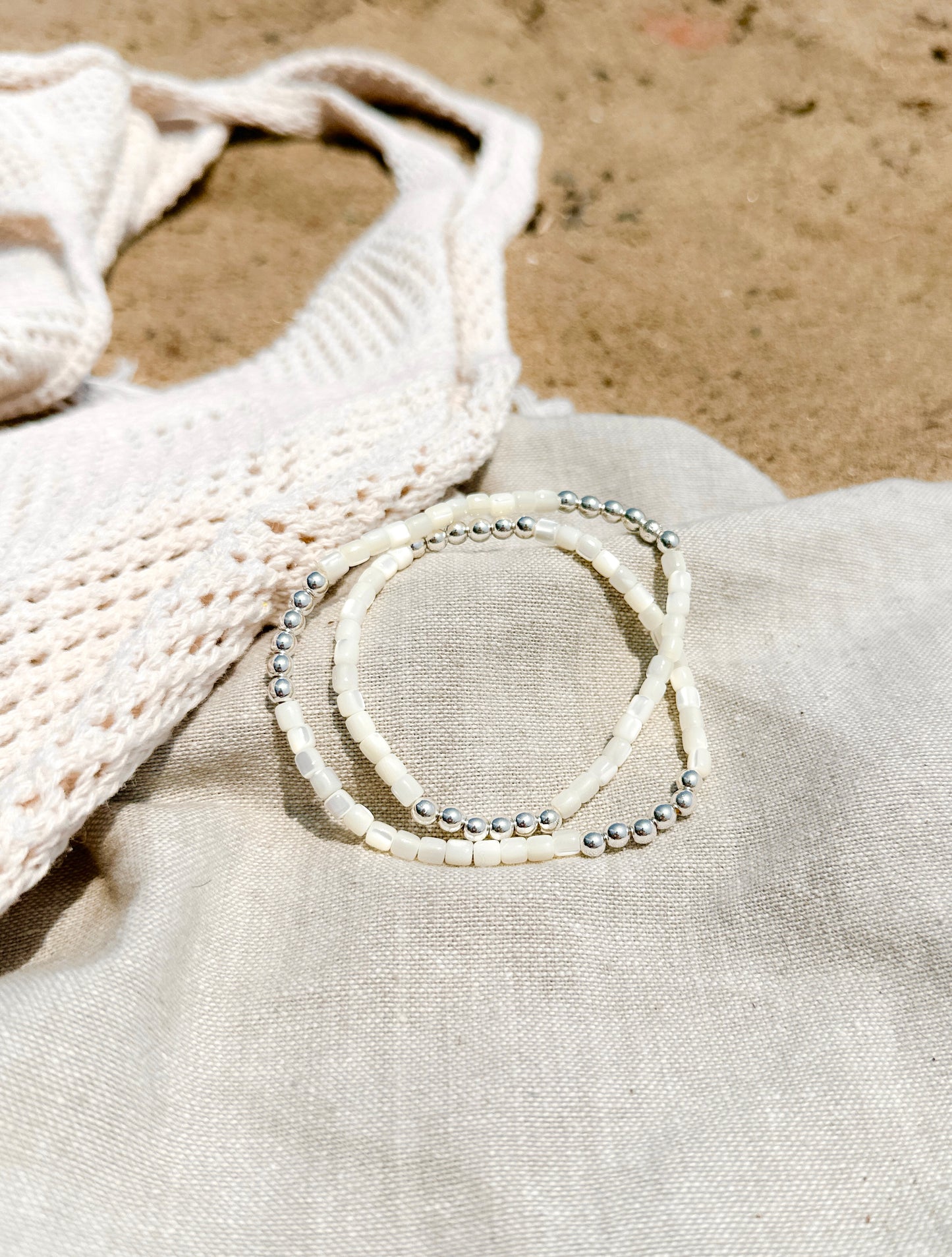 Introducing The Malia Double Wrap Bracelet, a captivating blend of elegance and healing energy. This exquisite bracelet features lustrous Mother of Pearl shell beads, known for their calming and nurturing properties. Each bead reflects a spectrum of iridescent hues, evoking the tranquil beauty of the ocean.