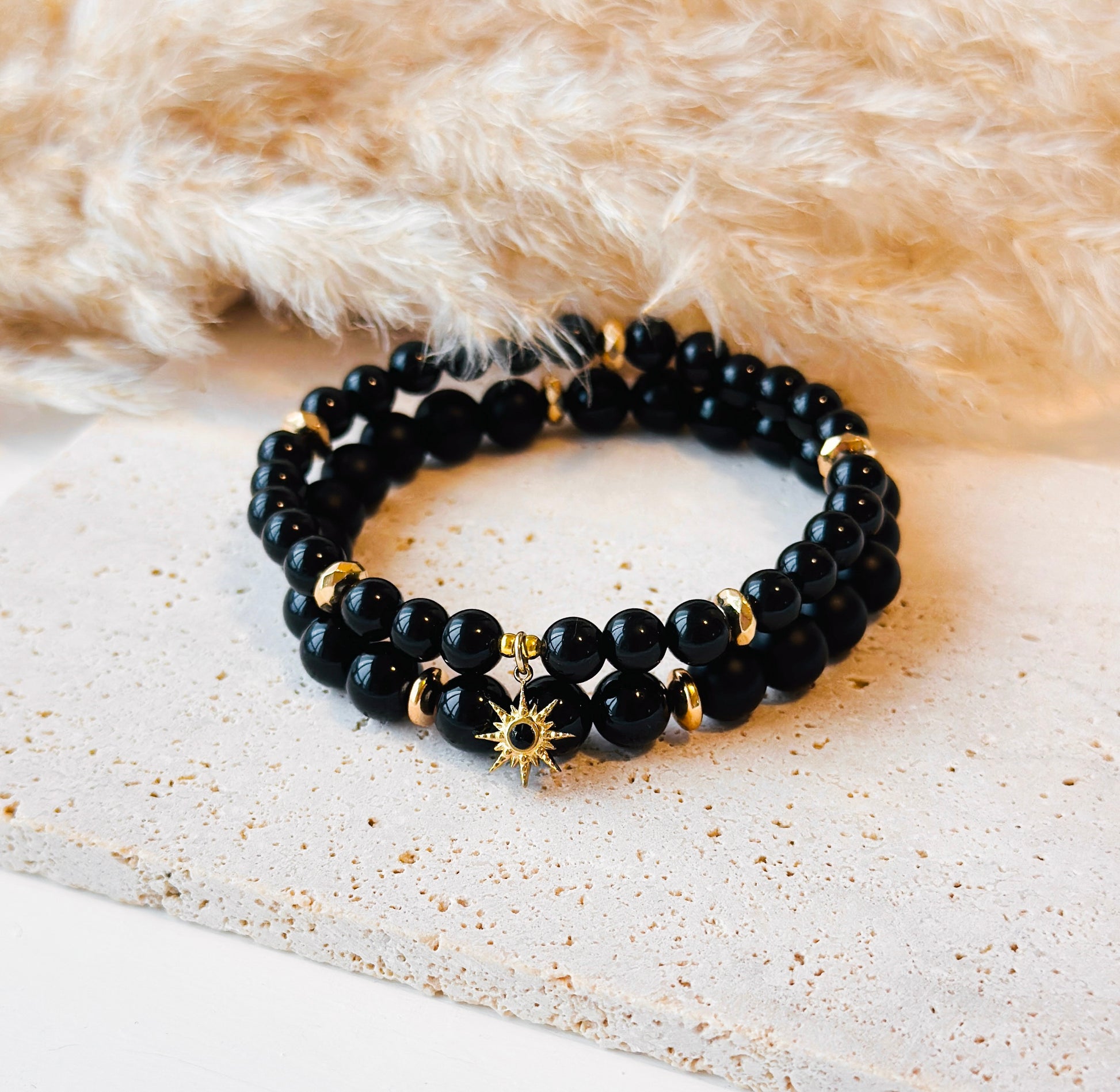  limited edition gemstone bracelet set, meticulously crafted with a striking combination of shiny and matte Onyx, adorned with a celestial touch—a gold star charm with an onyx gemstone center.