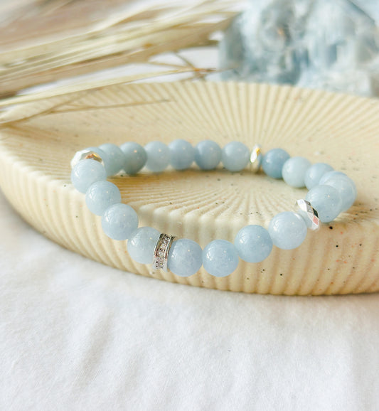 The Aqua Elegance Bracelet is more than just a beautiful accessory; it's a stunning embodiment of the serene and healing energies of aquamarine gemstones. Known for its captivating blue hues reminiscent of tranquil ocean waters, Aquamarine is celebrated for its various metaphysical properties.