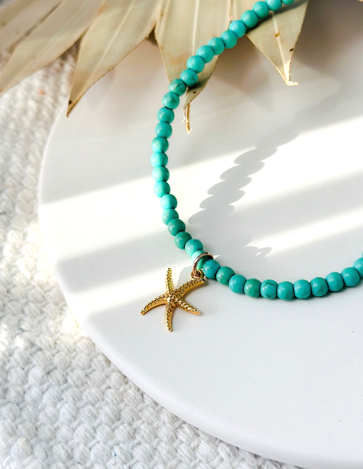 sea foam green anklet on stretch cord with a gold starfish charm