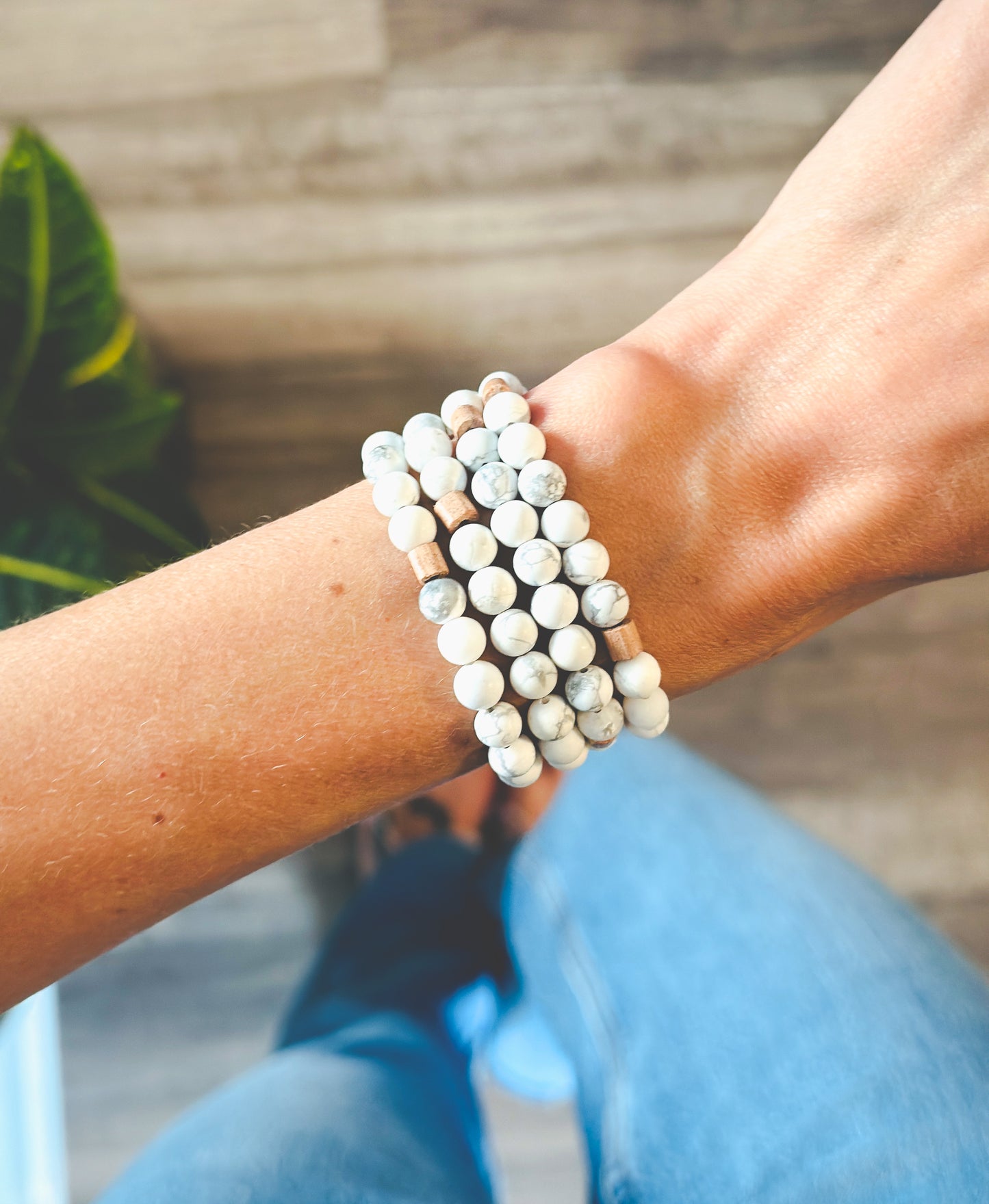 Model wearing a Matte Howlite gemstone wrap bracelet paired with Rosewood Rondelle beads for calming stress