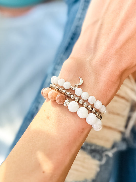 The sun and moon gemstone stacking bracelet set created with moonstone and sunstone and a moon charm